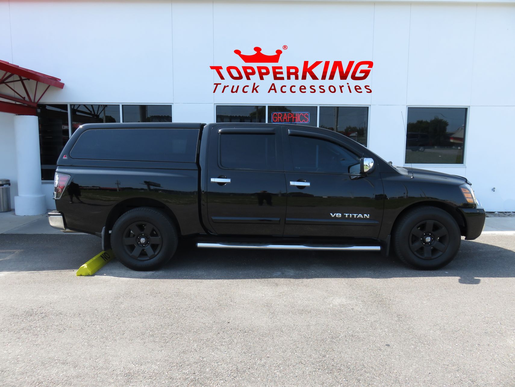 2005 Nissan Titan with LEER 100XQ, Nerf bars, Chrome Accessories, Tint, Hitch by TopperKING Brandon 813-689-2449 or Clearwater FL 727-530-9066. Call today!