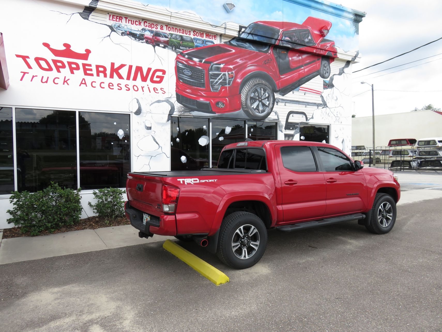 2017 Toyota Tacoma with LEER Ricochet, Black Out Nerf Bars, Tint, Hitch by TopperKING in Brandon, FL 813-689-2449 or Clearwater, FL 727-530-9066. Call Now!