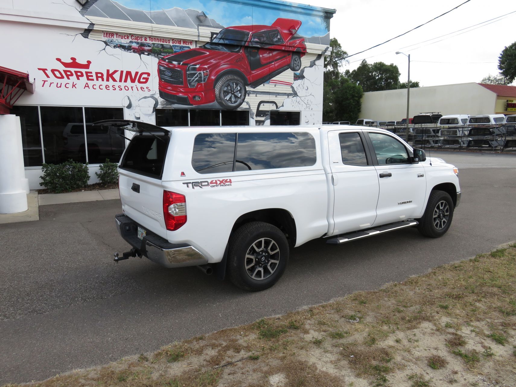 2017 Toyota Tundra with LEER 100XL, Nerf Bars, Hitch, Tint by TopperKING in Brandon, FL 813-689-2449 or Clearwater, FL 727-530-9066. Call today!