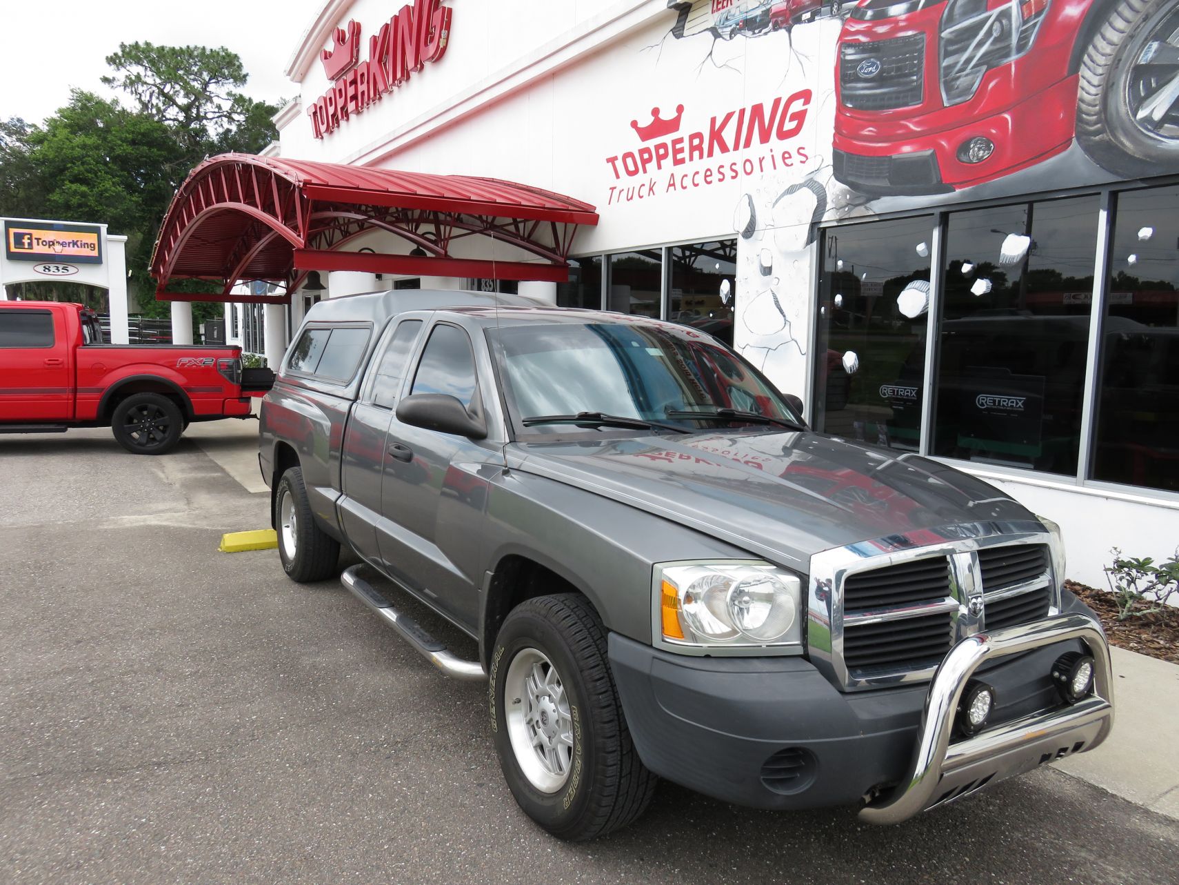 2007 Dodge Dakota with Leer 180, Bull Bars, Nerf Bars, Chrome, Tint, Hitch by TopperKING in Brandon FL 813-689-2449 or Clearwater FL 727-530-9066. Call us!