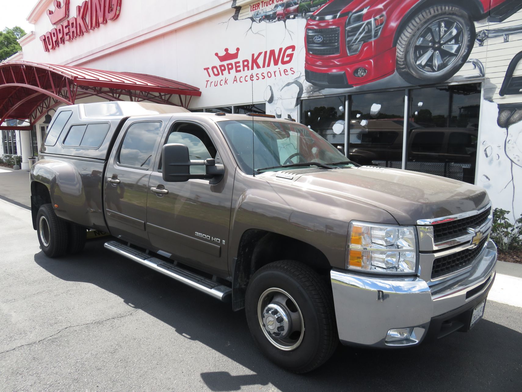 2013 Chevy Silverado with LEER 122, Nerf Bars, Hitch, Tint by TopperKING in Brandon, FL 813-689-2449 or Clearwater, FL 727-530-9066. Call today to start!