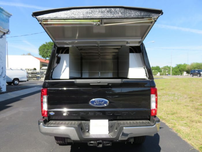 2019 Black Ford F250 LEER DCC Construction Topper, Nerf Bars, Hitch by TopperKING in Brandon, FL 813-689-2449 or Clearwater, FL 727-530-9066. Call today!