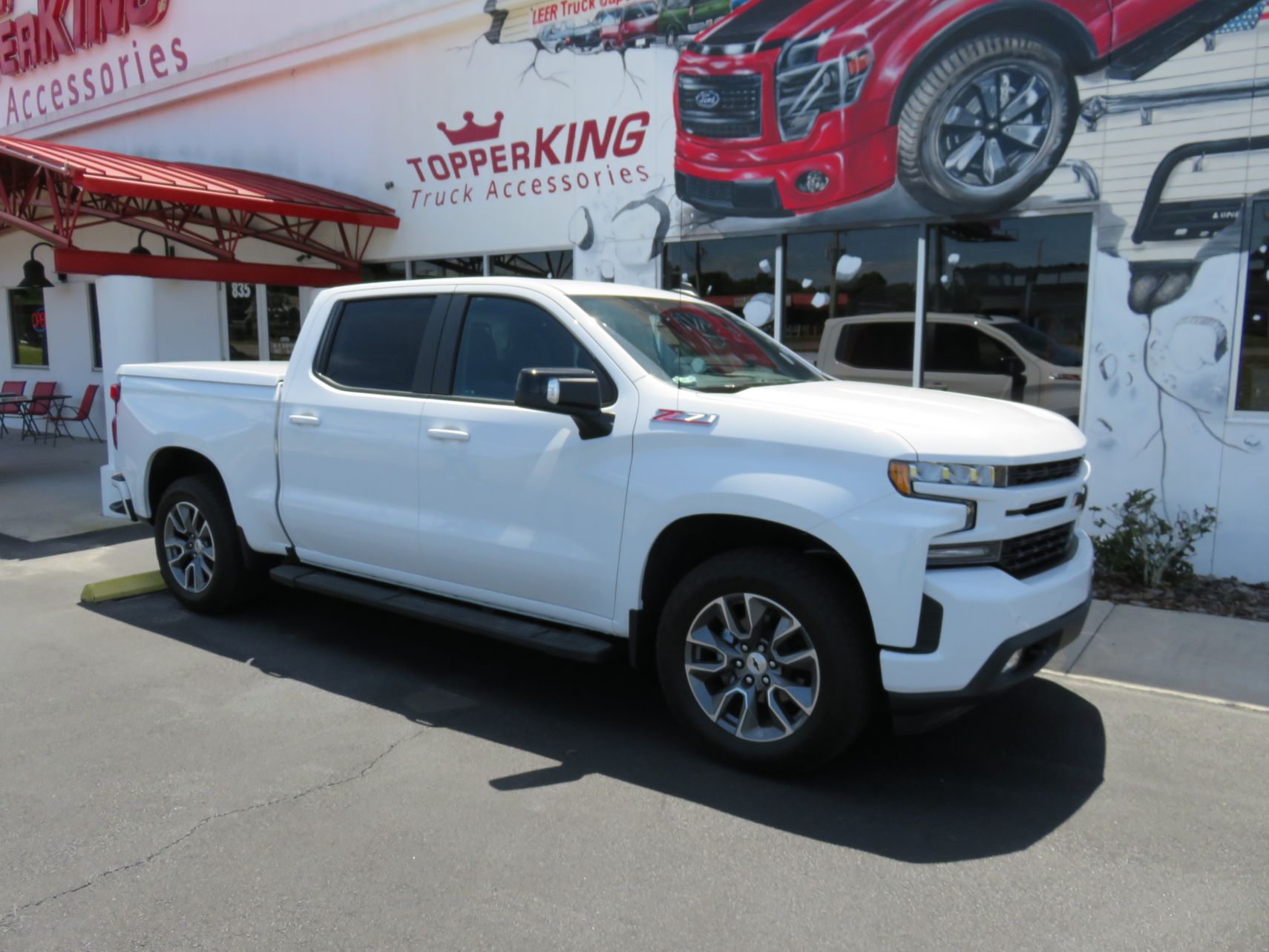 2019 Chevrolet Silverado with LEER 550, Hitch, Black Out Nerf Bars, Tint by TopperKING in Brandon, FL 813-689-2449 or Clearwater, FL 727-530-9066. Call Now!