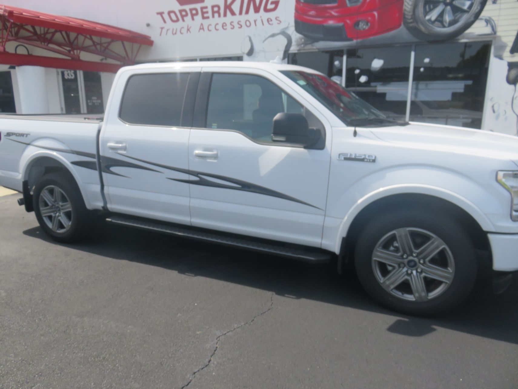 2017 Ford F150 with RollnLock Retractable Lid, Graphic, Nerf Bar, Tint, Hitch. TopperKING in Brandon 813-689-2449 Clearwater, FL 727-530-9066