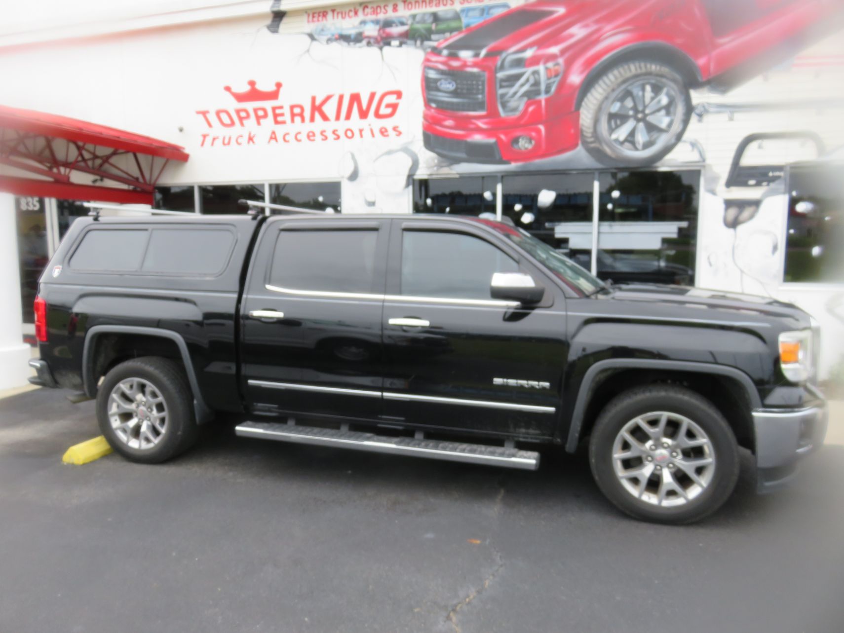 2018 GMC Sierra with TK Defender, Roof Racks, Vent Visors, Side Steps. Call TopperKING Brandon 813-689-2449 or Clearwater 727-530-9066.